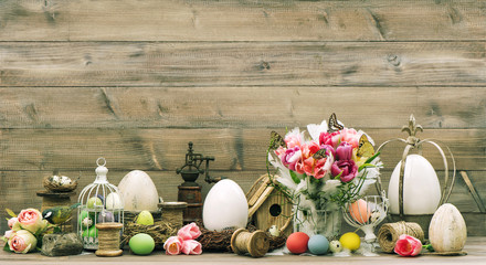 Easter decoration with pink tulip flowers and colored eggs