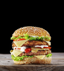 Hamburger on old wooden table.