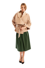 Young woman wearing light colour coat and green skirt
