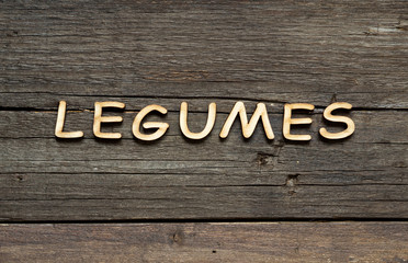 The word of Legumes on a wooden table