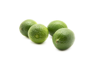 Limes with slices and leaves isolated on white background