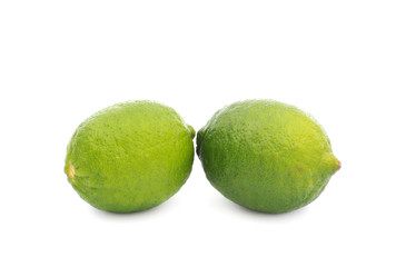 Limes with slices and leaves isolated on white background