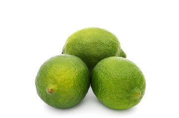 Limes with slices and leaves isolated on white background