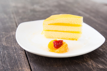 Orange cake slice on the wood table