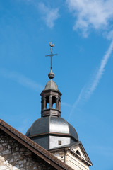 Fototapeta na wymiar Church Steeple with Cross in small Town of France