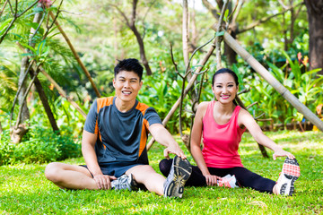 Naklejka premium Asian couple having outdoor fitness sport training