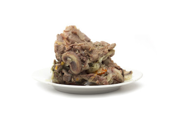 Bone with meat on a plate. Photo.