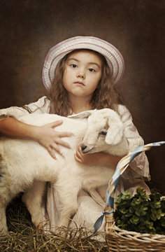Portrait of a little girl with her pet goat