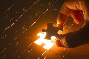 Missing jigsaw puzzle piece with light glow