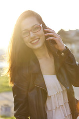 Girl talking on the phone in the sunset