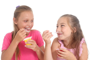 happy girls eating yogurt