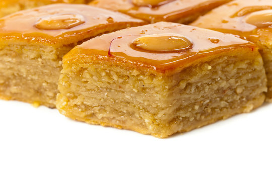 Baklava with almonds on white background