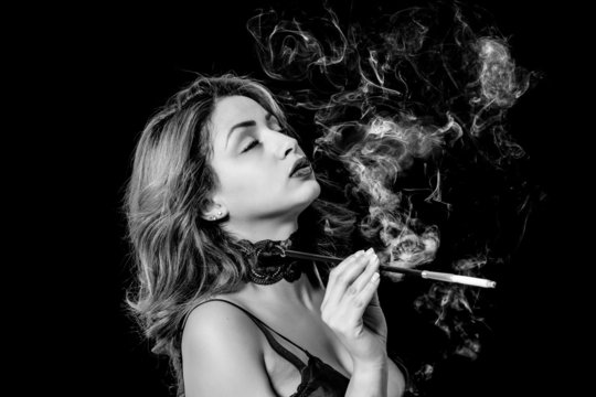 Sexy woman with cigarette holder smoking black and white