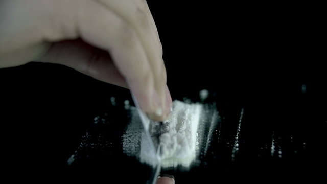 Making snorting lines while somebody throws a pack of bills on the table 