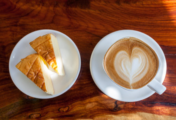 Cup of latte coffee with cake