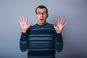 European-looking male of about thirty raised his hands palms out