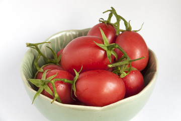 Close-up fresh tomatoes in green bowl