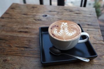 A cup of coffee mocha on wooden