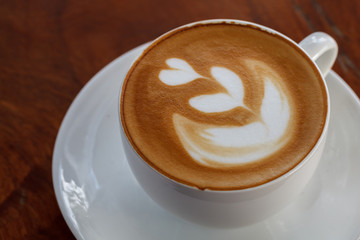 Cup of latte coffee on wooden