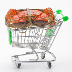 Hairy crabs on the shopping cart isolated in white background.