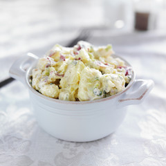 potato salad shot with selective focus in stoneware