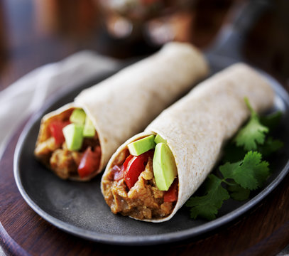 Two Vegan Burritos With Avocado, Tomato And Lentils