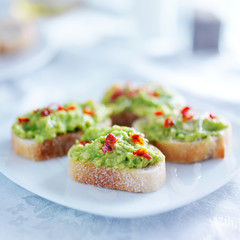 spicy avocado spread on toasted crustini