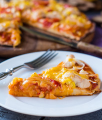 slice of pizza with chicken, corn, tomatoes and double cheese