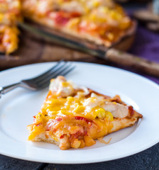 slice of pizza with chicken, corn, tomatoes and double cheese