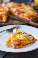slice of pizza with chicken, corn, tomatoes and double cheese