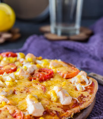 pizza with chicken, corn, tomatoes and double cheese