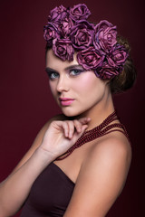 Naklejka premium Beautiful young woman with artificial rouses on head necklace an