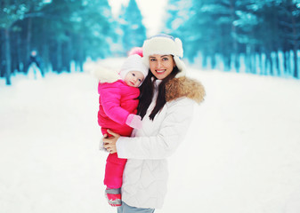 Portrait of a pretty mother and baby in the winter day
