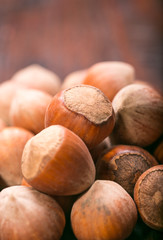 Hazelnuts on old wooden background