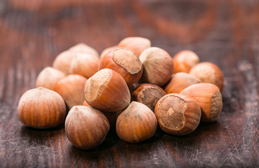 Hazelnuts on old wooden background