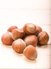 Hazelnuts on old wooden background