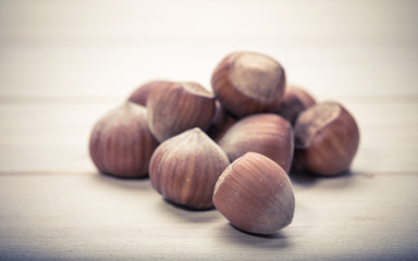 Hazelnuts on old wooden background