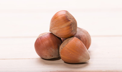 Hazelnuts on old wooden background