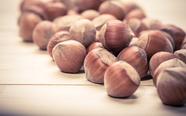 Hazelnuts on old wooden background