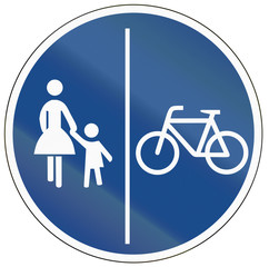 German traffic sign on a shared-use path with separate lanes, left lane for pedestrians and right lane for bicycles