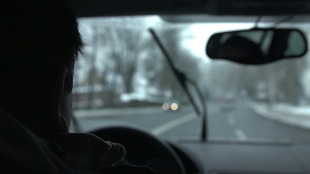Driving a car on a highway on a cold winter day