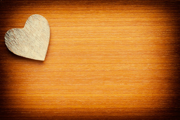 Wooden heart on a grunge wooden background