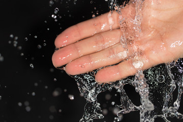 Fototapeta premium hand in water on a black background