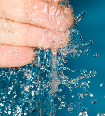 Fototapeta premium fingers in water on a blue background