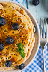 Homemade golden pancake with fresh berrys and mint