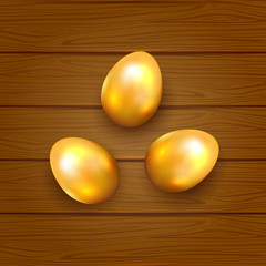 Golden Easter eggs on wooden background