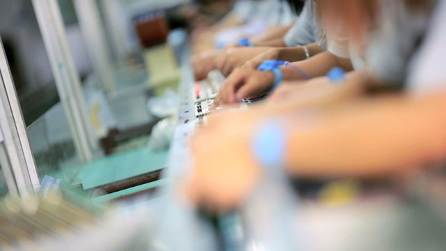 PCBs being assembled by factory workers, China