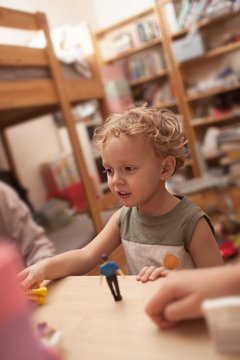 Little boy playing with toys in the room