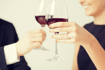 engaged couple with wine glasses
