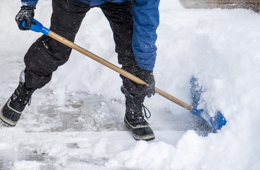 Naklejka premium Man Removing Snow from His Driveway